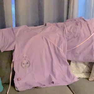 Scrubs by Shirley’s uniforms.lavender/pink piping embroideron left top/right hip